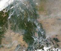 Forest fires can be seen blazing across British Columbia, August 21, 2003.