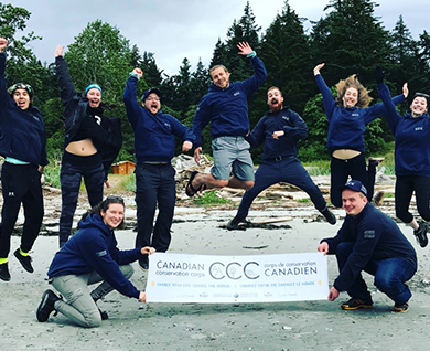 tripod members holding banner