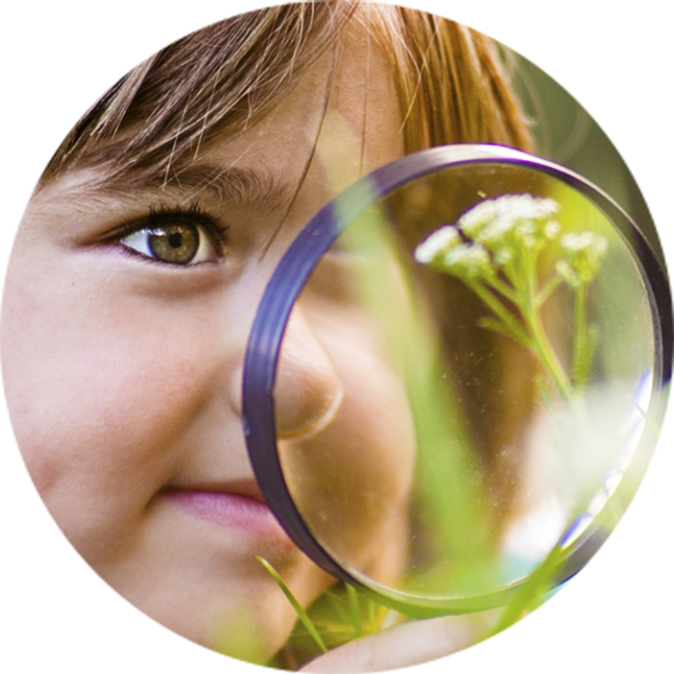child with magnifying glass