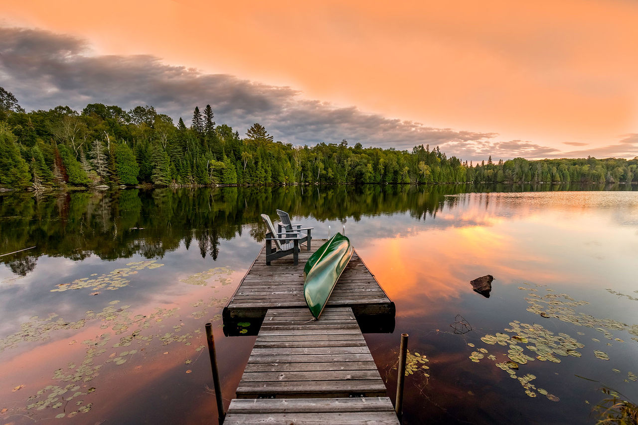dock lake canoe chairs sunset