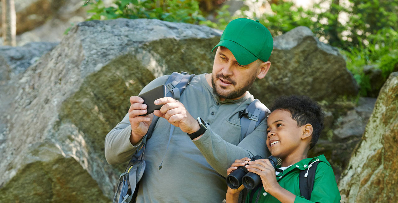 father son outside inaturalist phone explore